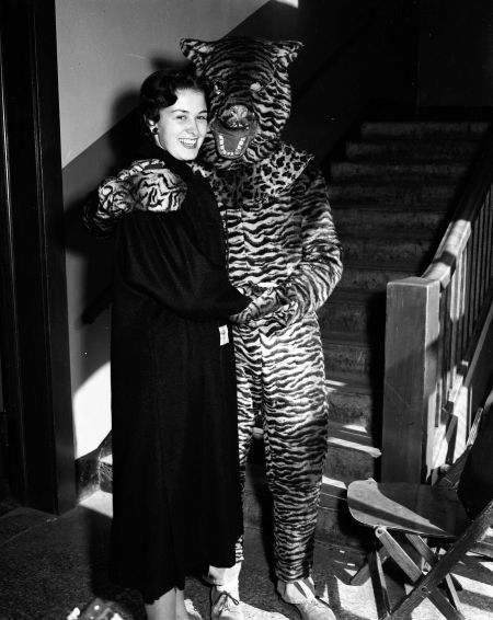 Homecoming queen candidate posed with the College of St. Thomas mascot, Tommy Tiger, 1957.