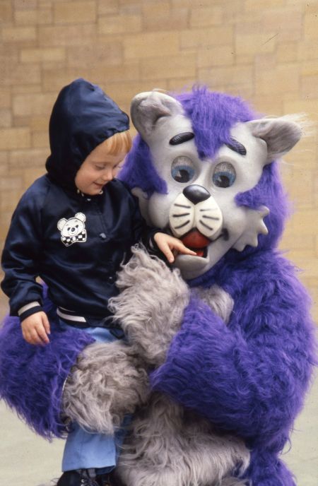 The College of St. Thomas mascot, Tommie holding Robert Callander, 1984.